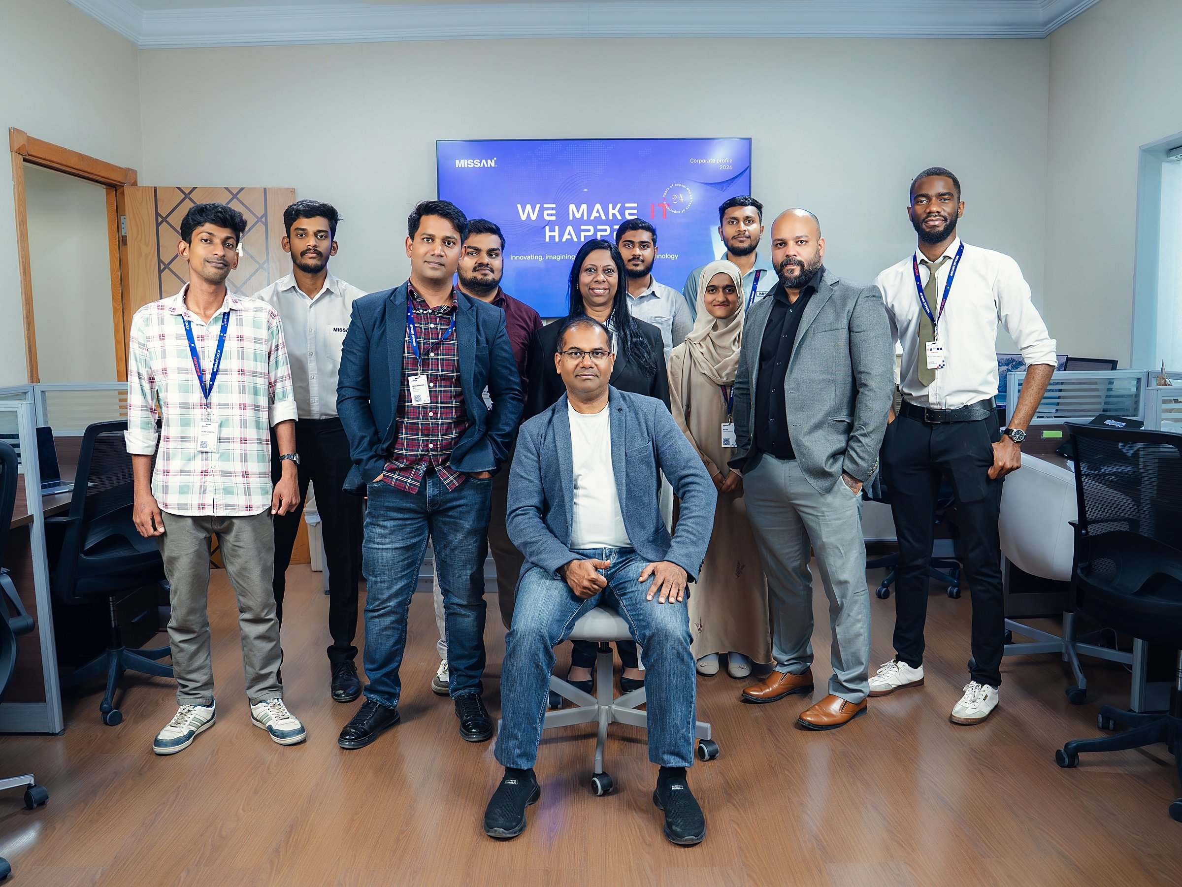 The Missan team at the Sharjah head office, with founder and CEO Abu Amir seated in front of a "We make IT happen" screen